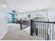Hallway leading to a bonus room with many windows and a hanging chandelier at 7501 Independence Dr, Zionsville, IN 46077