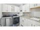 Laundry room featuring modern washer and dryer and white cabinets at 7501 Independence Dr, Zionsville, IN 46077