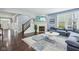 Bright living room with a fireplace, large windows, and a comfortable sofa, creating a cozy atmosphere at 7501 Independence Dr, Zionsville, IN 46077