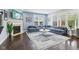 Cozy living room featuring a fireplace, comfortable sectional sofa, and large windows, perfect for relaxation at 7501 Independence Dr, Zionsville, IN 46077