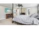 Primary bedroom with a four-poster bed, ceiling fan, and TV at 7501 Independence Dr, Zionsville, IN 46077
