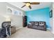 Office space with a large window, a brown leather sofa, and blue accent wall at 7501 Independence Dr, Zionsville, IN 46077