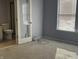 Sunlit bedroom with carpeted floors and an ensuite bathroom at 7675 Mistflower Ln, Noblesville, IN 46062
