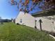 Side view of the home showing the siding, lawn, and tree in bloom at 7675 Mistflower Ln, Noblesville, IN 46062