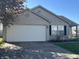 Charming single-story home with an attached two car garage and landscaped front yard at 7675 Mistflower Ln, Noblesville, IN 46062