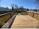 A backyard deck looks over the large fenced-in yard at 833 W Franklin St, Shelbyville, IN 46176