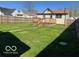 View of a large backyard with a wooden fence and deck that is perfect for entertaining at 833 W Franklin St, Shelbyville, IN 46176