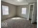 Inviting bedroom with plush carpet, dual windows, and closet for ample storage space at 833 W Franklin St, Shelbyville, IN 46176