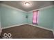 Cozy bedroom with soft carpet, light-filled window and neutral wall color at 833 W Franklin St, Shelbyville, IN 46176