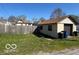 Backyard view of one car garage, some lawn, fence and neighboring properties at 833 W Franklin St, Shelbyville, IN 46176