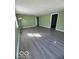 Open living room with updated flooring and plenty of natural light streaming through the window at 833 W Franklin St, Shelbyville, IN 46176