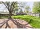 Large backyard with a lush green lawn, mature trees, a shed, and a wooden fence providing privacy at 908 N Bolton Ave, Indianapolis, IN 46219