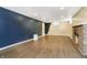 Spacious basement with wood-look flooring and brick fireplace at 908 N Bolton Ave, Indianapolis, IN 46219