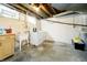 Unfinished basement with laundry area, utility sink, and block foundation ready for your personal touch at 908 N Bolton Ave, Indianapolis, IN 46219