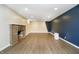 Basement with fireplace, blue accent wall and drop lighting at 908 N Bolton Ave, Indianapolis, IN 46219