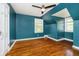Bedroom showcasing wooden floor, ceiling fan and two windows offering ample sunlight at 908 N Bolton Ave, Indianapolis, IN 46219