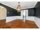 Bright dining room with hardwood floors, wainscoting, and an ornate chandelier at 908 N Bolton Ave, Indianapolis, IN 46219