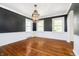 Sun-filled dining room featuring hardwood floors and classic wainscoting at 908 N Bolton Ave, Indianapolis, IN 46219