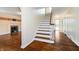 Elegant foyer with hardwood floors, staircase, fireplace, and ample natural light at 908 N Bolton Ave, Indianapolis, IN 46219