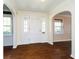 Bright foyer with hardwood floors, arched doorways, and large windows for natural light at 908 N Bolton Ave, Indianapolis, IN 46219