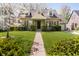 Charming brick home with beautiful front lawn, landscaping, and welcoming stone walkway at 908 N Bolton Ave, Indianapolis, IN 46219