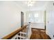 Upstairs hallway with hardwood flooring and a cozy window bench at 908 N Bolton Ave, Indianapolis, IN 46219