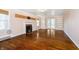 Empty living room featuring hardwood floors, fireplace, and sliding glass doors at 908 N Bolton Ave, Indianapolis, IN 46219
