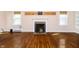 Bright living room with hardwood floors, fireplace, and large windows at 908 N Bolton Ave, Indianapolis, IN 46219