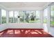 Bright sunroom with tiled floors and multiple windows overlooking the backyard at 908 N Bolton Ave, Indianapolis, IN 46219