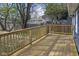 Wooden deck with a railing and a view of the fenced backyard and mature trees at 914 N Bancroft St, Indianapolis, IN 46201