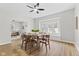 Bright dining room features a ceiling fan, wood floors, and a large window with natural light at 914 N Bancroft St, Indianapolis, IN 46201