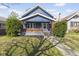 Charming blue two-story home with a cozy front porch, landscaped yard and brick accents, located in a neighborhood setting at 914 N Bancroft St, Indianapolis, IN 46201