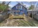 Backyard view of a blue home with a wooden deck and a small patch of grass at 914 N Bancroft St, Indianapolis, IN 46201