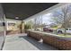 Inviting covered front porch with brick accents, offering a relaxing outdoor space with views of the neighborhood at 914 N Bancroft St, Indianapolis, IN 46201