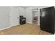 View of the kitchen with black appliances, wood floors and a connected dining room area at 914 N Bancroft St, Indianapolis, IN 46201