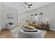 Bright living room with wood floors, ceiling fan, modern decor and comfortable seating, offering a relaxing atmosphere at 914 N Bancroft St, Indianapolis, IN 46201
