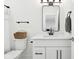 Bathroom with modern fixtures including a toilet, sink with vanity, mirror, and a towel rack at 9725 Thorne Cliff Way # 105, Fishers, IN 46037