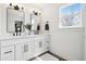 Well-lit, modern bathroom with double vanity, contemporary fixtures, and large mirrors at 9725 Thorne Cliff Way # 105, Fishers, IN 46037