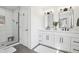 Modern bathroom featuring double vanities, contemporary fixtures, and a glass-enclosed walk-in shower at 9725 Thorne Cliff Way # 105, Fishers, IN 46037