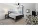 Cozy bedroom featuring a black bed frame, neutral walls, and modern ceiling fan at 9725 Thorne Cliff Way # 105, Fishers, IN 46037