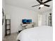 Bright bedroom with a ceiling fan, a workspace featuring dual monitors and natural light at 9725 Thorne Cliff Way # 105, Fishers, IN 46037