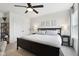 Bedroom with black bed frame, complemented by a ceiling fan, and decorative wall art at 9725 Thorne Cliff Way # 105, Fishers, IN 46037