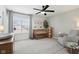 Charming Bedroom with crib, rocker, large window, and soft, neutral colors at 9725 Thorne Cliff Way # 105, Fishers, IN 46037