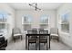 Minimalist dining area with black table and black chairs, with two chairs on each side and light colored walls at 9725 Thorne Cliff Way # 105, Fishers, IN 46037