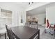 Dining area leading into the living area and overlooking the backyard, and adjacent to the home office at 9725 Thorne Cliff Way # 105, Fishers, IN 46037