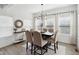 Bright dining room with light wood floors, modern chandelier, and lots of natural light at 9725 Thorne Cliff Way # 105, Fishers, IN 46037
