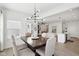Open concept dining room with a view of the kitchen and living room with the same light wood floors at 9725 Thorne Cliff Way # 105, Fishers, IN 46037