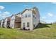 Back view of home featuring a deck, access to green space, and multiple windows for natural light at 9725 Thorne Cliff Way # 105, Fishers, IN 46037