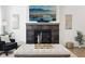 Close-up of the fireplace, featuring dark gray tile, a wooden mantel, and a mounted television above at 9725 Thorne Cliff Way # 105, Fishers, IN 46037