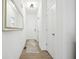 Bright hallway featuring modern lighting, a stylish mirror, and clean white doors, creating a welcoming entrance at 9725 Thorne Cliff Way # 105, Fishers, IN 46037